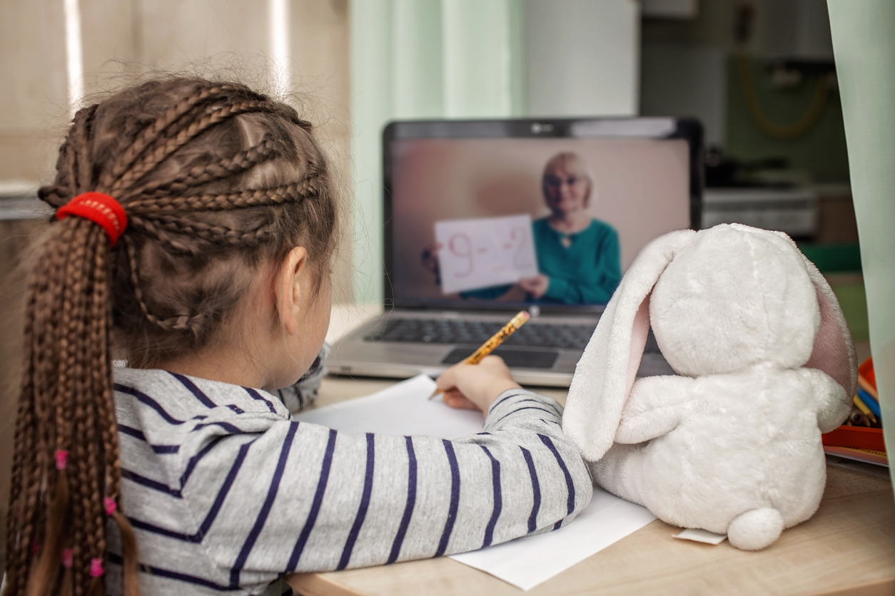 Pretty stylish schoolgirl studying math during her online lesson at home, social distance during quarantine, highlighting Five Back-To-School Health Tips During the Coronavirus Pandemic.