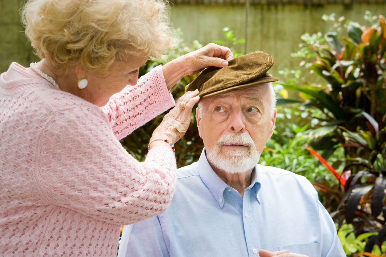 Loving wife cares for her elderly husband with alzheimers disease, knowing the early warning signs of Alzheimer's disease.