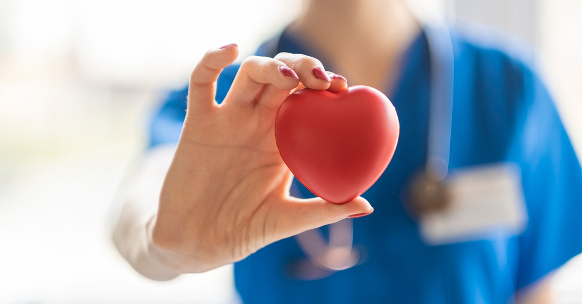 Doctor holding heart shaped stress ball.