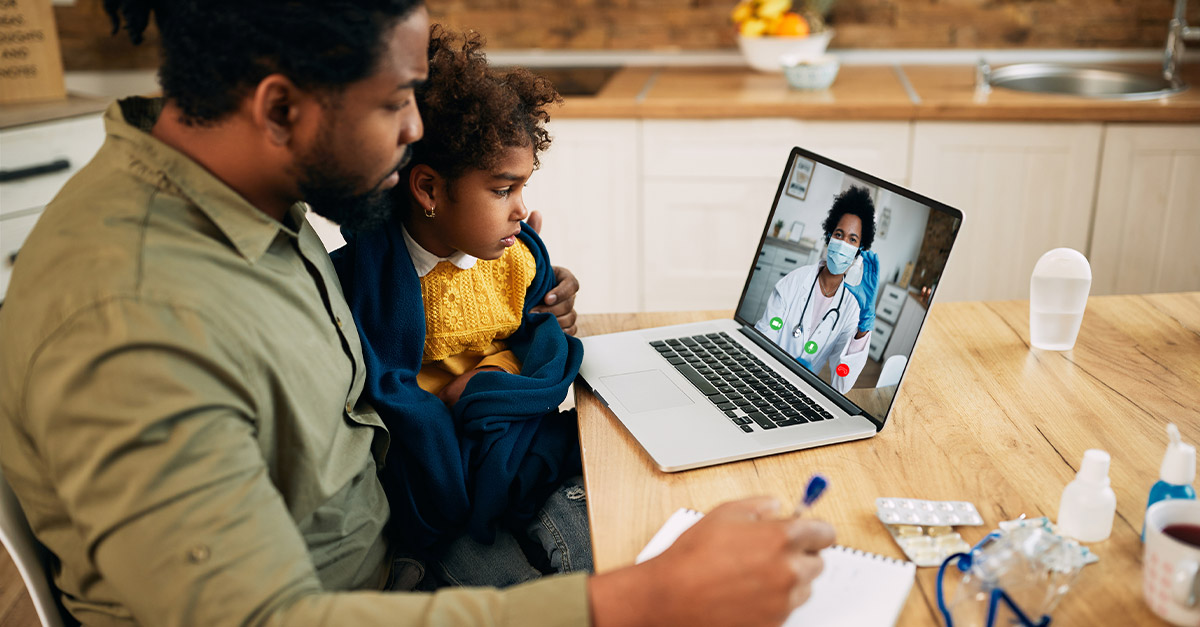 Sick father and son during a telehealth appointment.