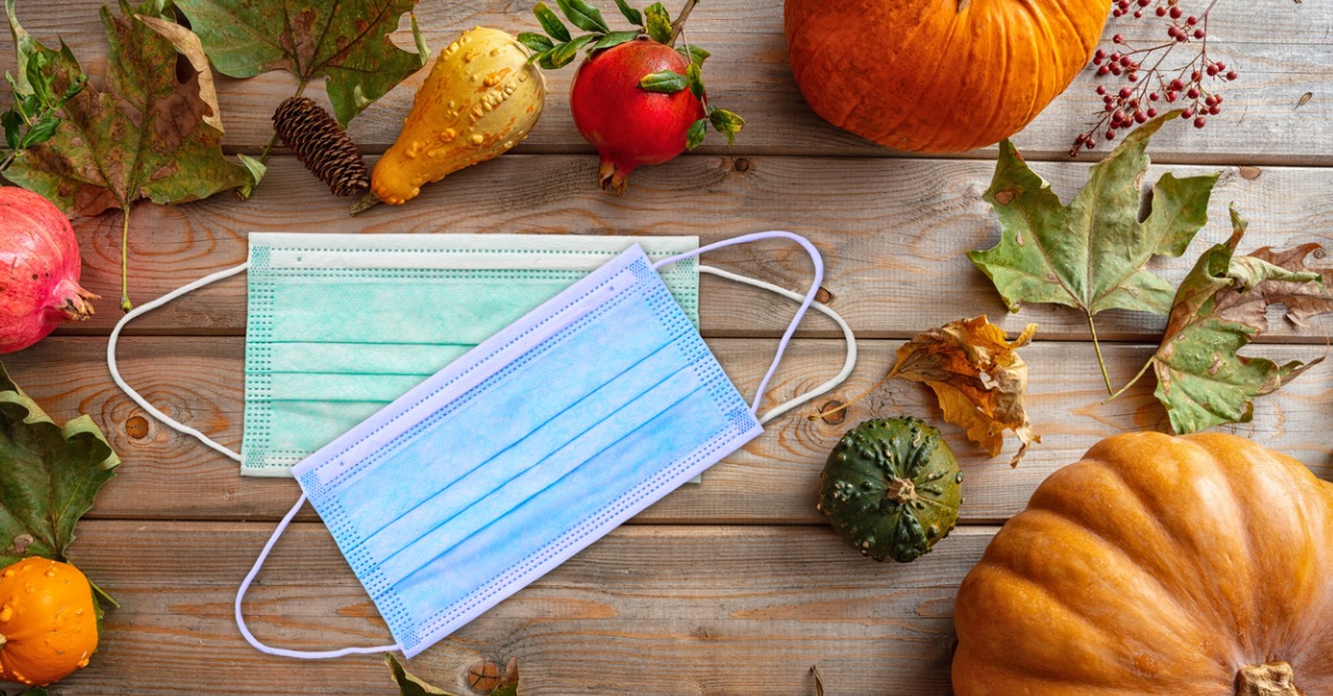 Face masks on top of Thanksgiving decorations.