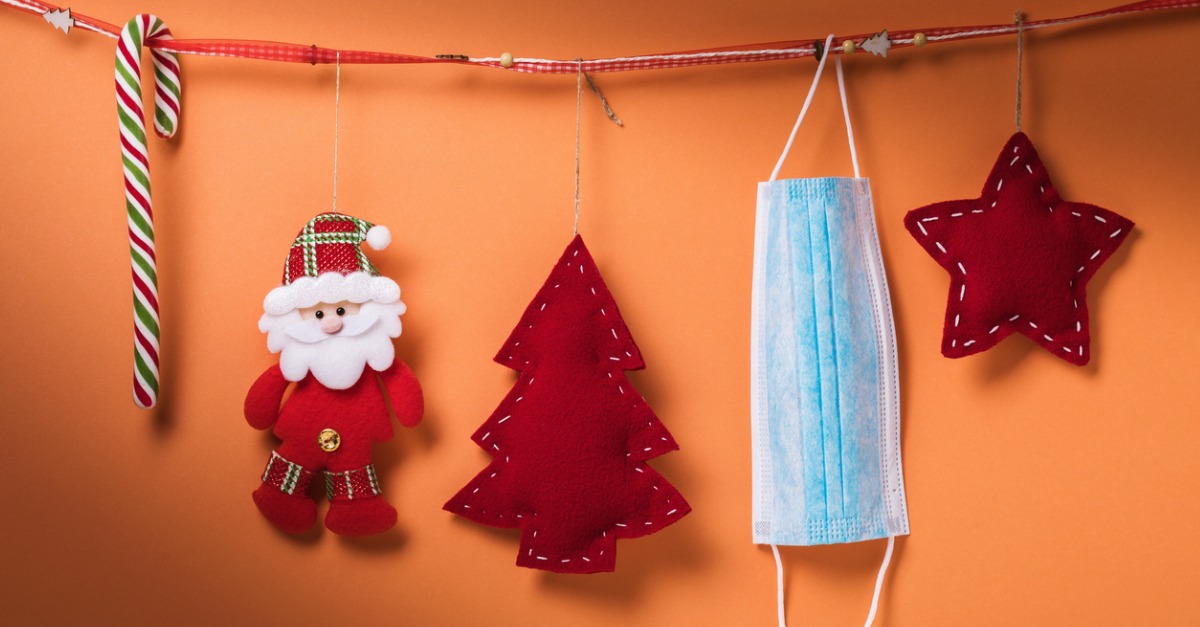 Mask hanging with Christmas decorations.