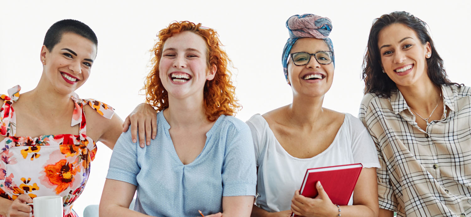 Four diverse women, happy smiling together.