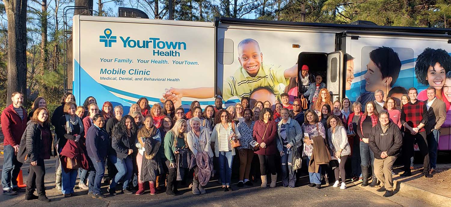 YourTown Health staff in front of the YourTown Health mobile clinic.