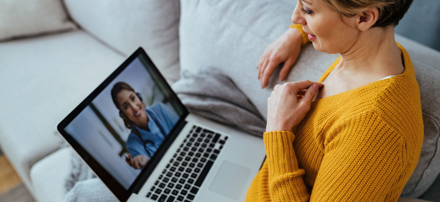 Patient having a TeleHealth appointment with her doctor on her laptop.