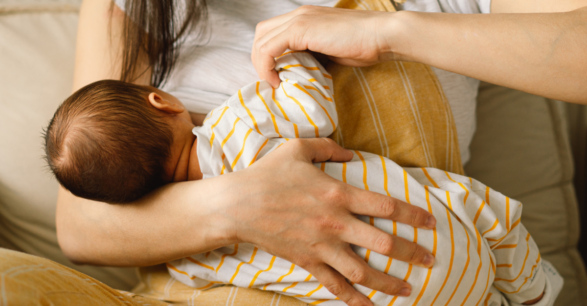 Woman breastfeeding newborn baby