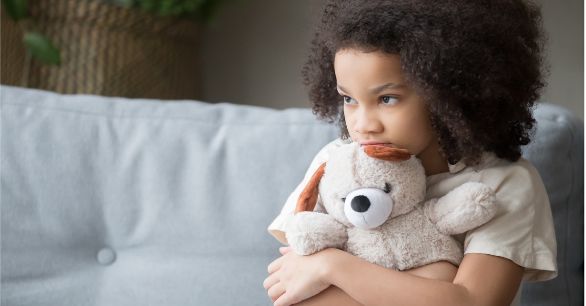 kid holding stuffed animal