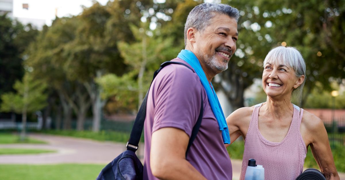 Senior couple smiling outside